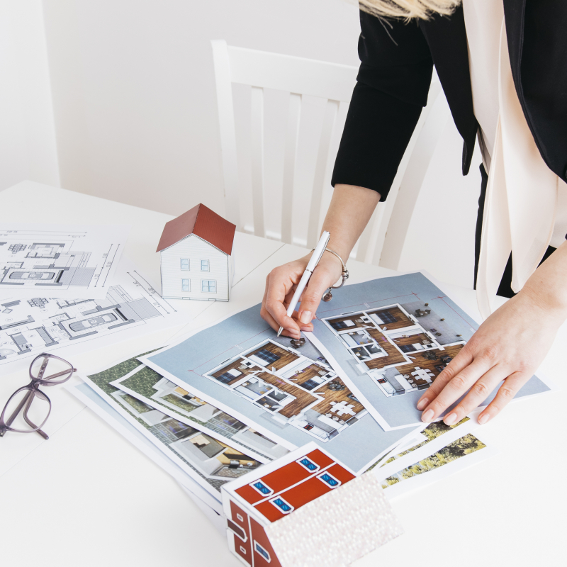 close-up-of-woman-hand-holding-pen-working-on-blueprint-in-office